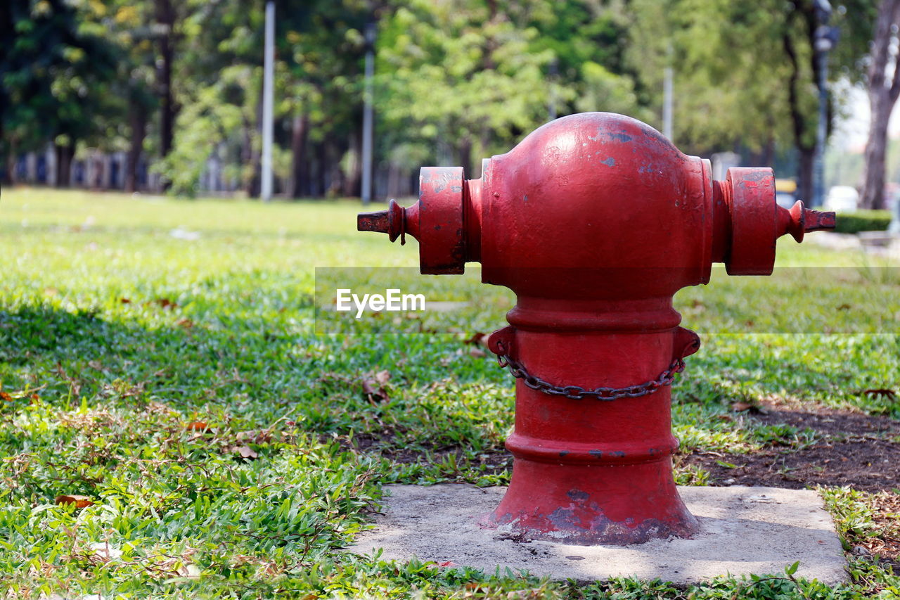 CLOSE-UP OF FIRE HYDRANT ON FIELD