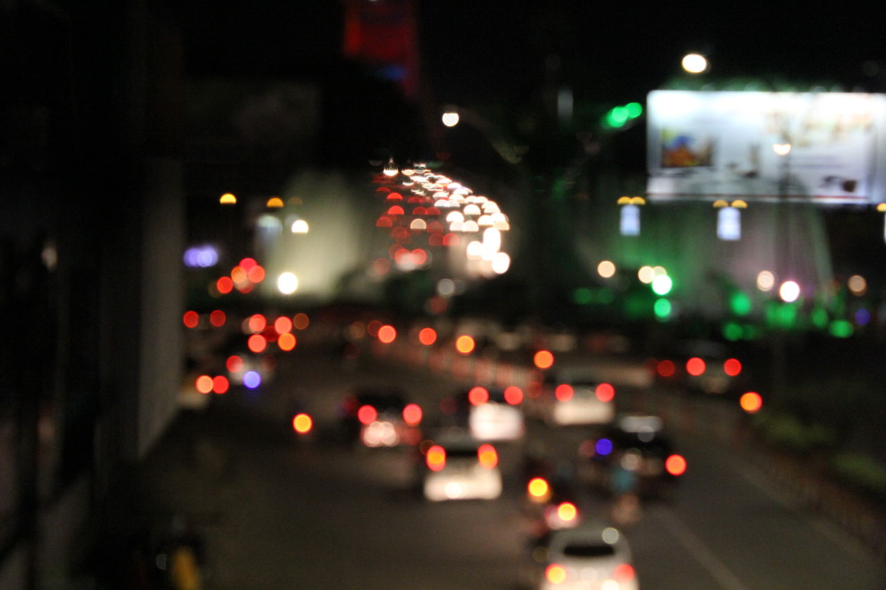 Defocused image of illuminated city at night