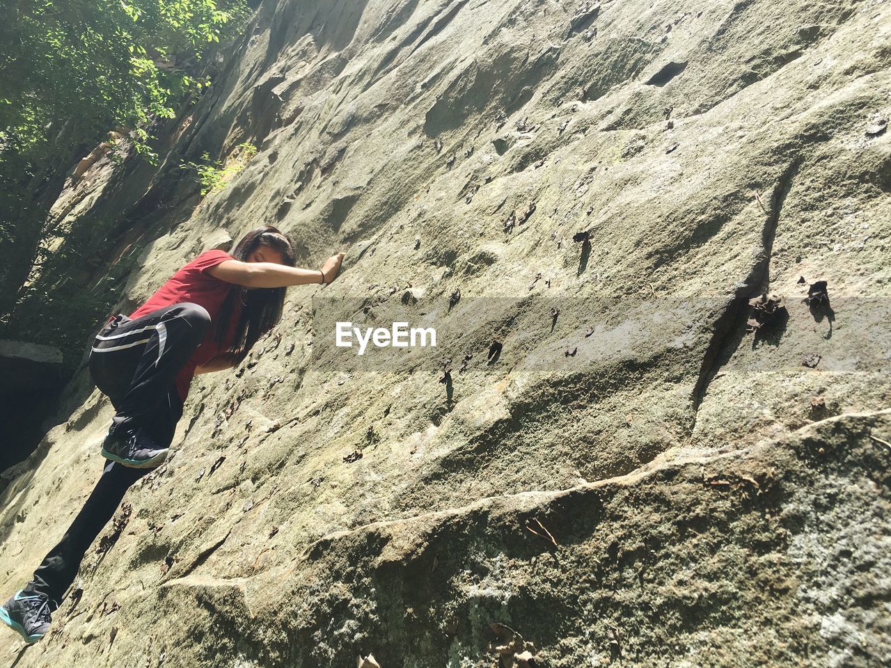 FULL LENGTH OF MAN ON ROCK IN SUNLIGHT