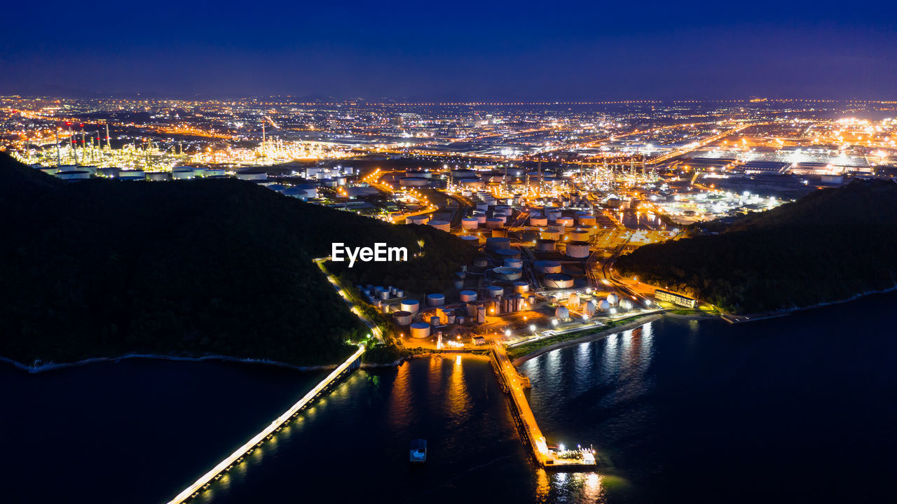 High angle view of illuminated city against sky at night