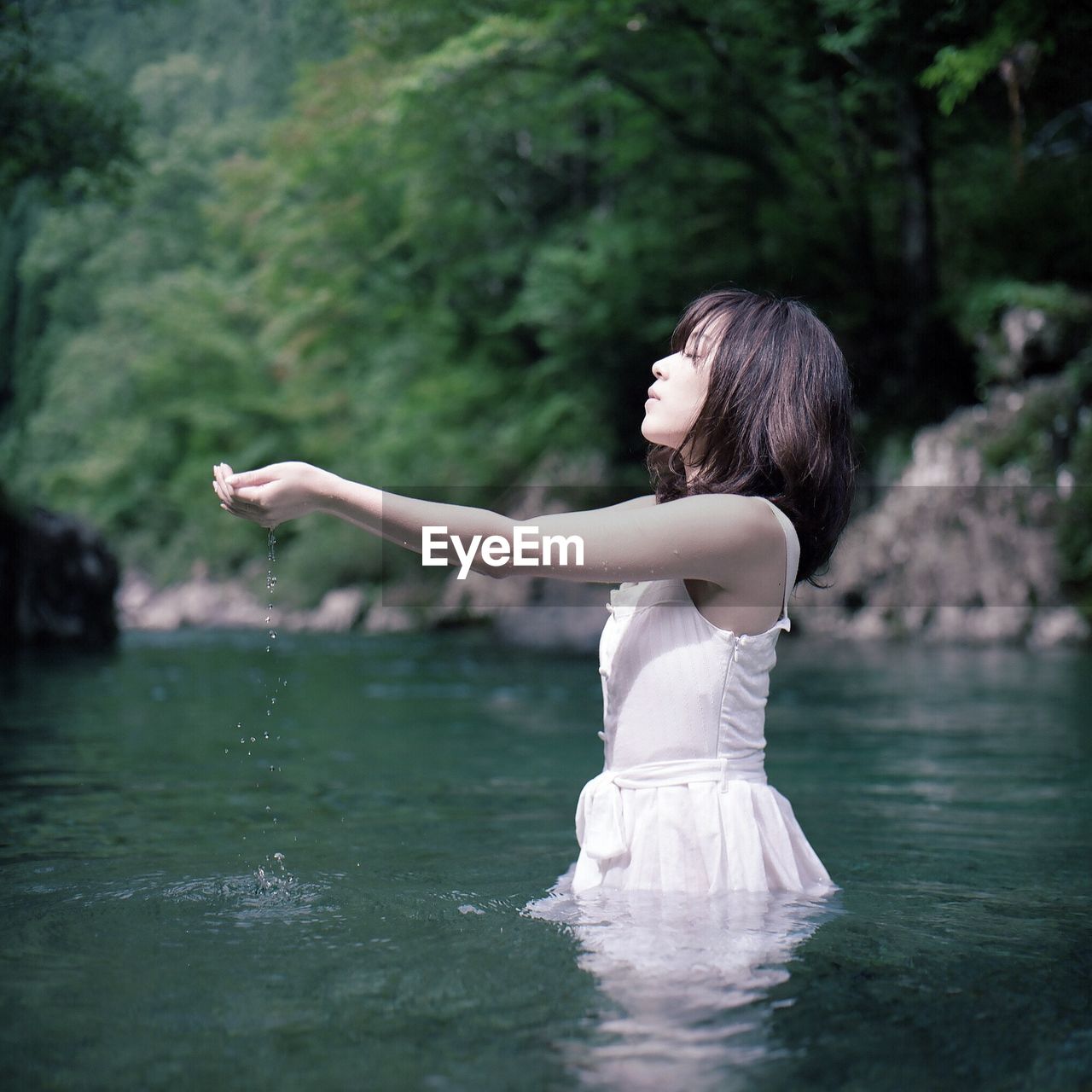 WOMAN STANDING IN LAKE