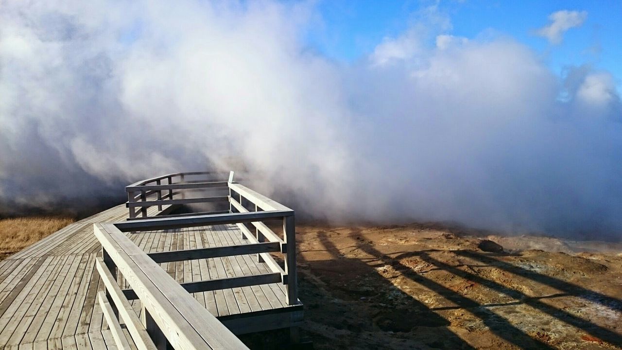 Wooden pier by hot spring and smoke