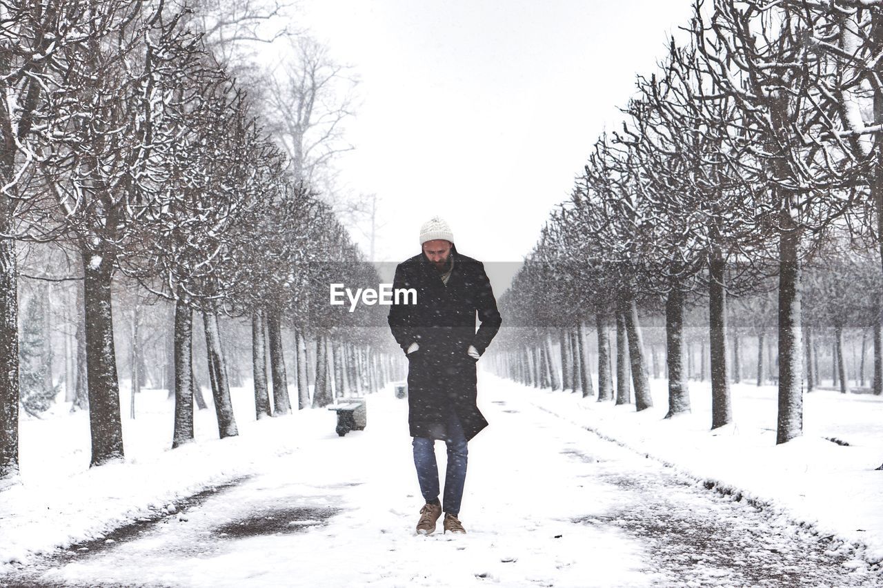 Portrait of man in snow covered park