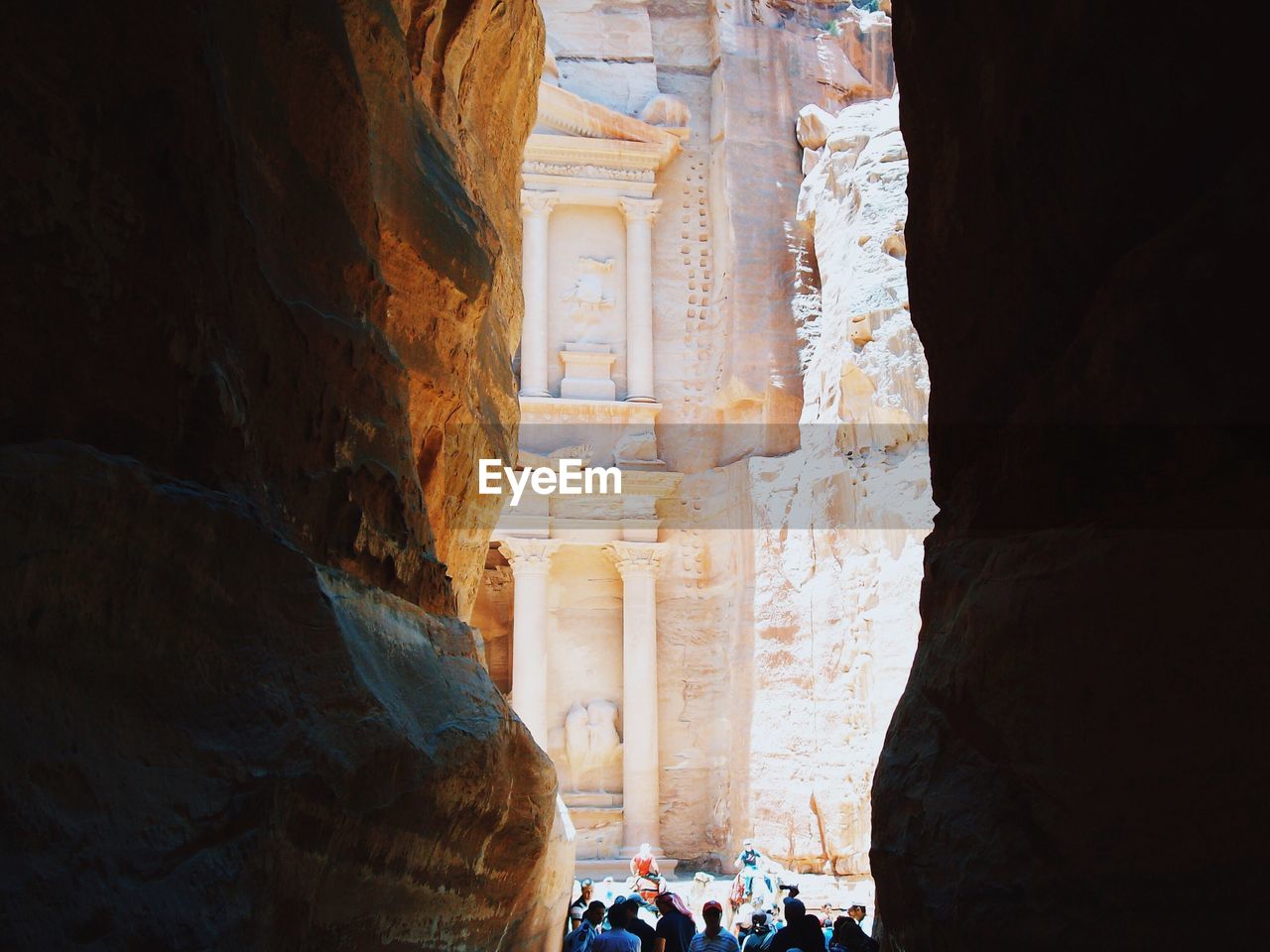 People amidst rock formations at petra