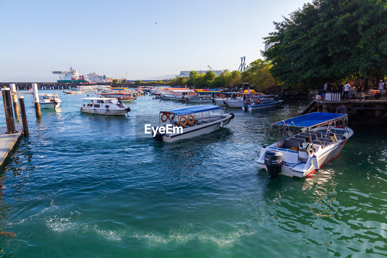 BOATS MOORED IN SEA