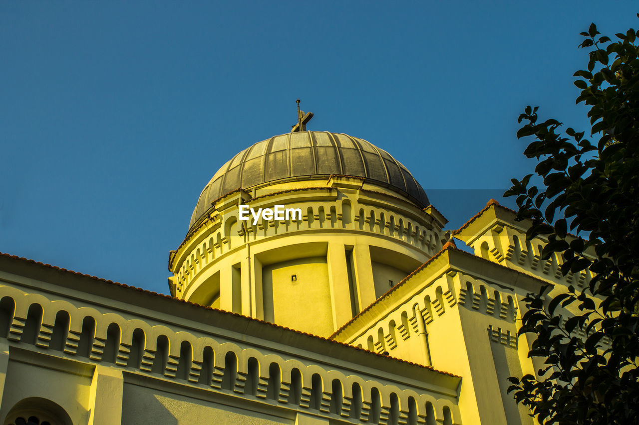 Exterior of church against clear blue sky