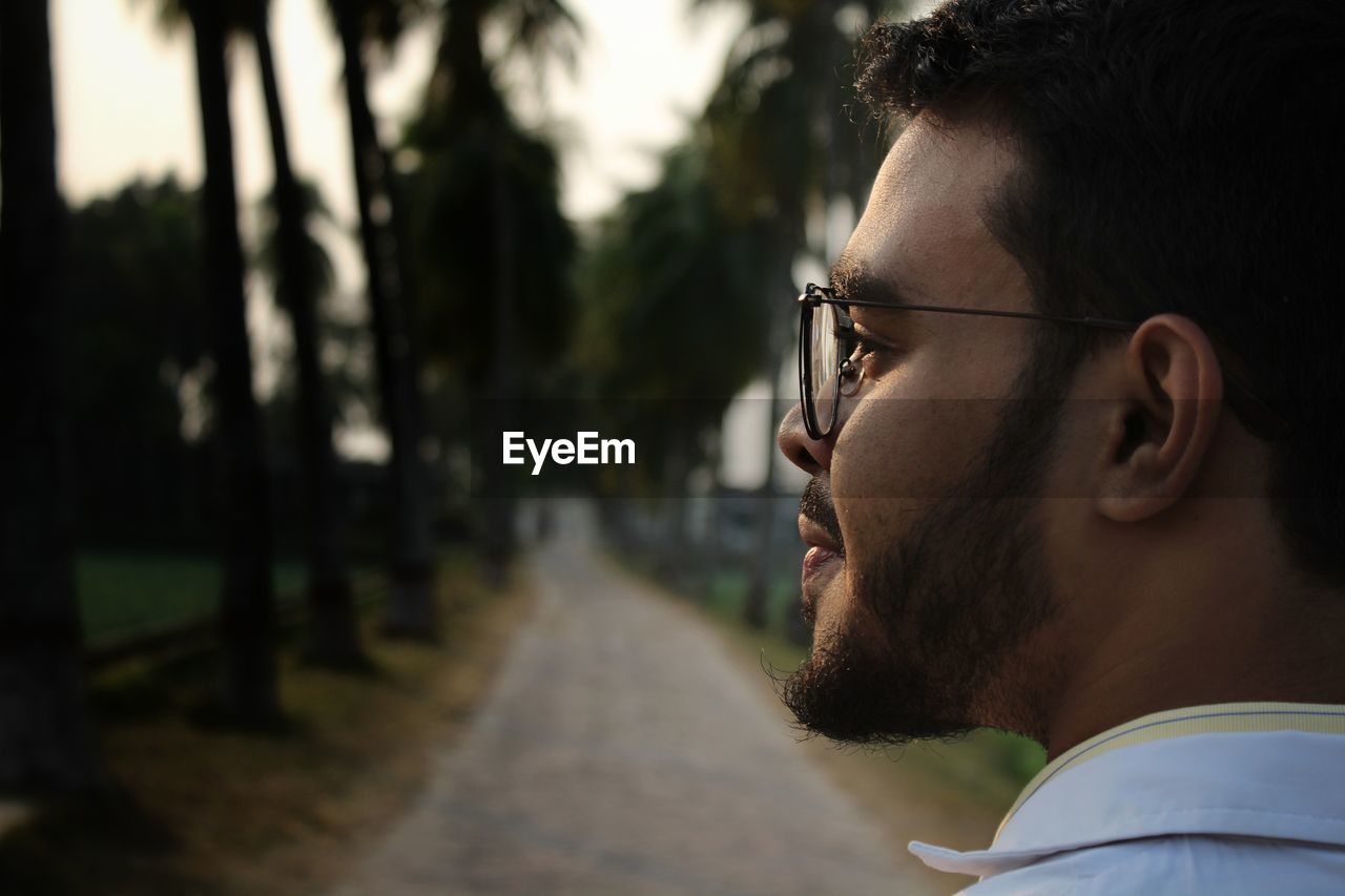 CLOSE-UP PORTRAIT OF YOUNG MAN WITH EYEGLASSES