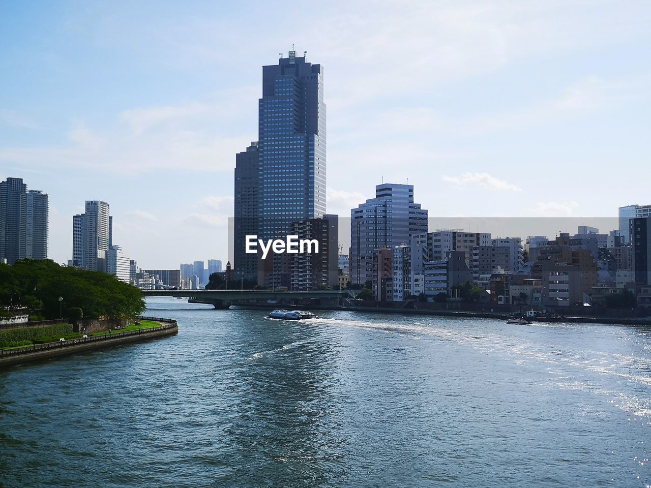 River amidst buildings in city against sky