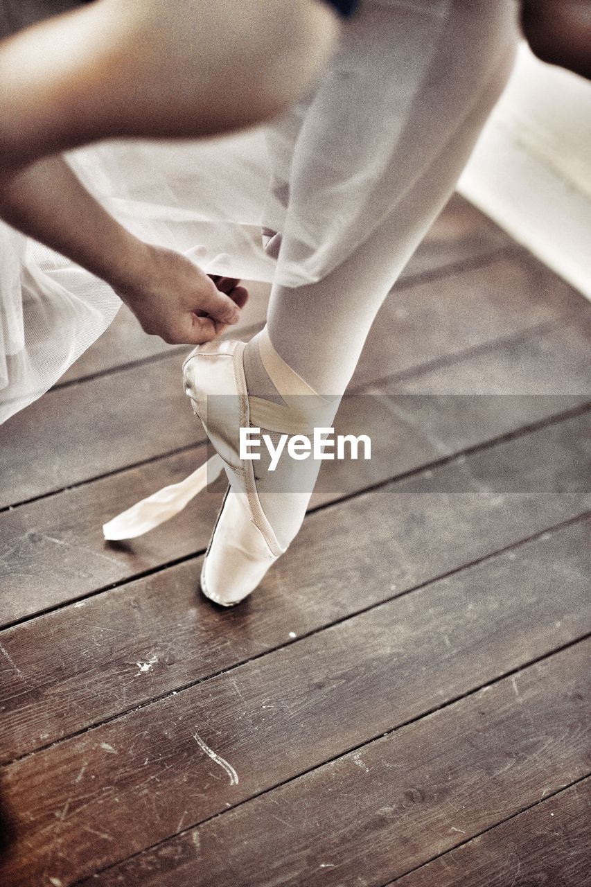 Low section of ballet dancer on floorboard