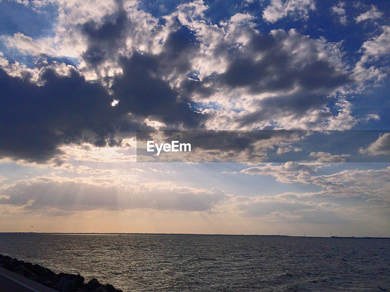 View of calm sea against clouds