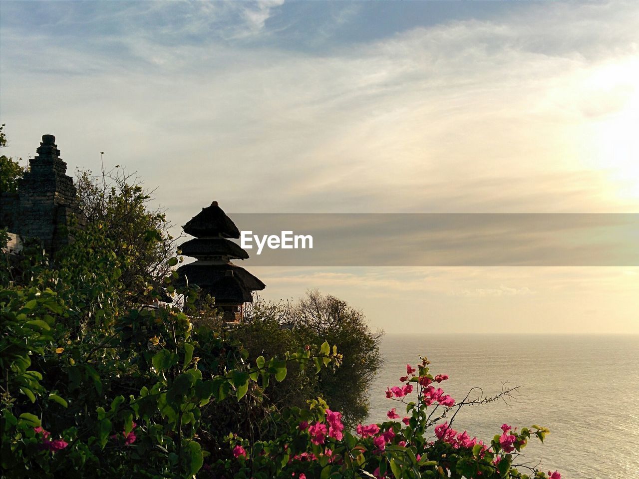 Uluwatu temple by sea against sky