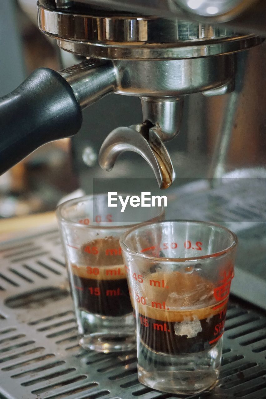 Close-up of coffee pouring in glass