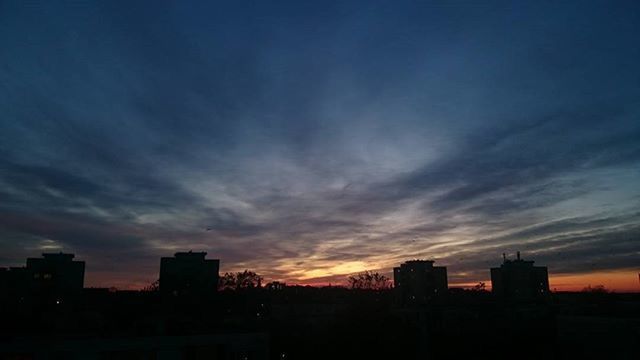 SILHOUETTE OF CITYSCAPE AT SUNSET