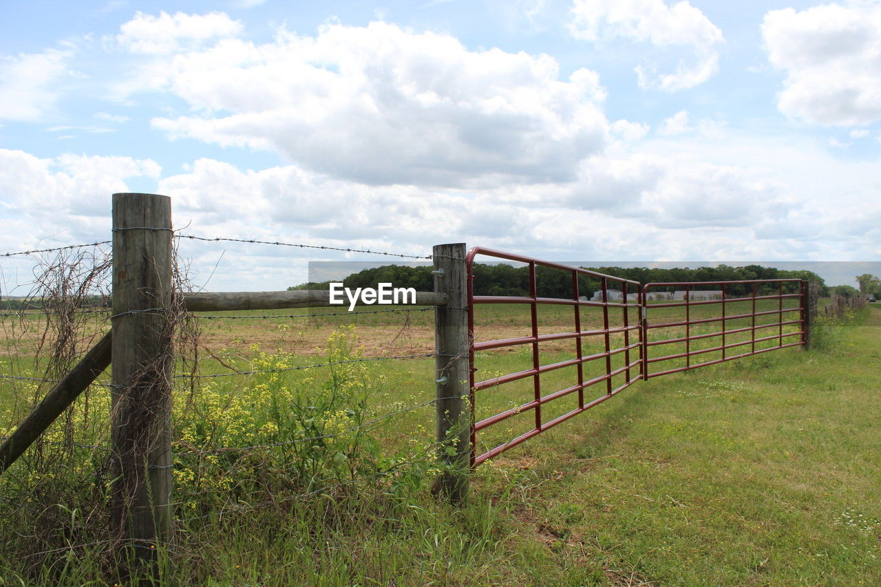 fence, sky, pasture, cloud, landscape, grass, land, plant, nature, security, protection, field, gate, rural scene, environment, home fencing, outdoor structure, no people, split-rail fence, wood, tranquility, scenics - nature, day, agriculture, outdoors, tranquil scene, wire, green, beauty in nature, non-urban scene, rural area, farm, plain, architecture, ranch, barbed wire, prairie, tree