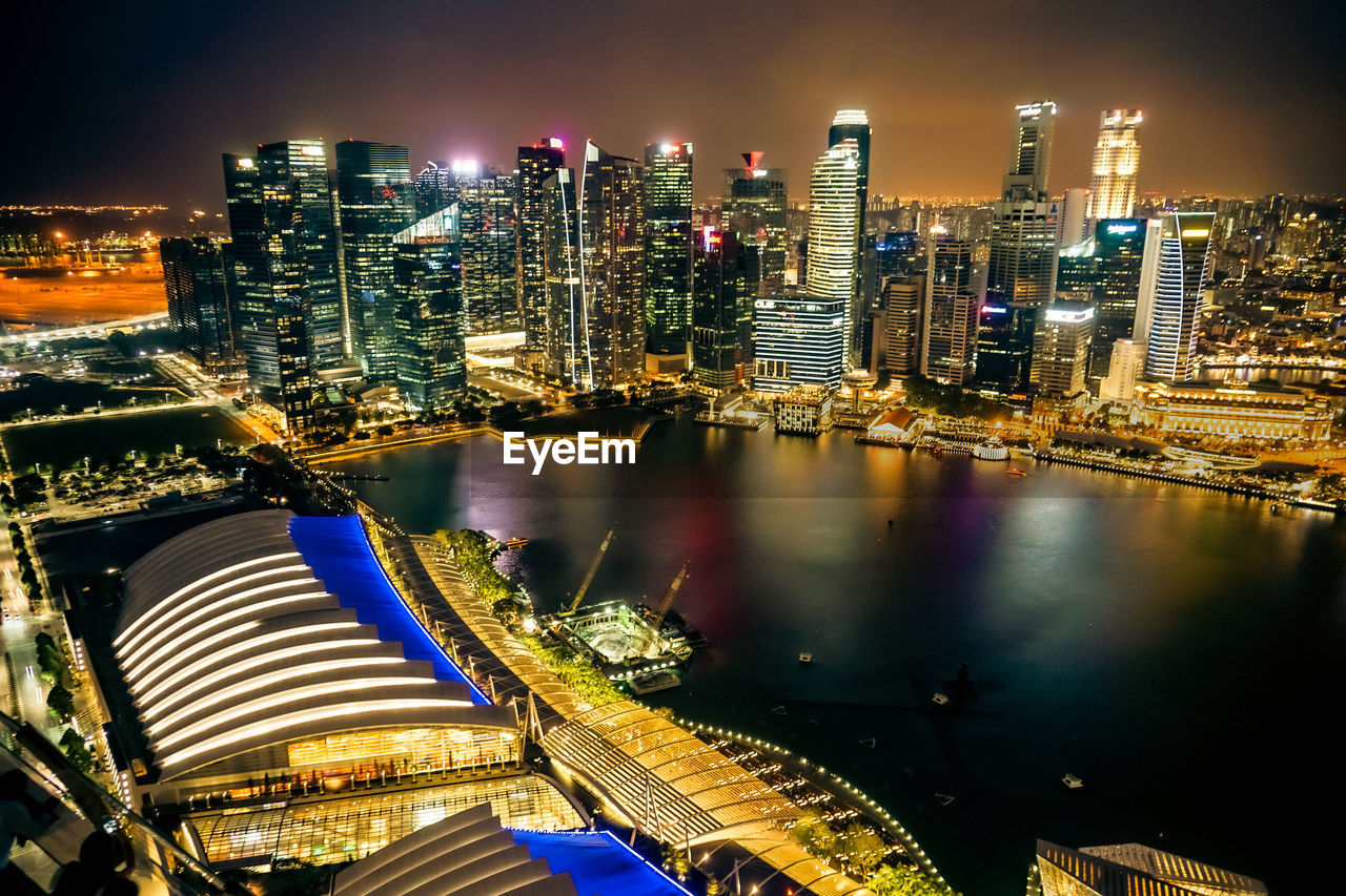 architecture, city, building exterior, built structure, office building exterior, skyscraper, cityscape, night, building, metropolis, illuminated, skyline, metropolitan area, urban skyline, landscape, urban area, travel destinations, sky, residential district, downtown district, city life, downtown, water, reflection, landmark, nature, transportation, no people, office, evening, high angle view, travel, dusk, outdoors, financial district, business, street, river, aerial view, long exposure, horizon, tower, tourism, development, business finance and industry, nautical vessel, harbor, tower block