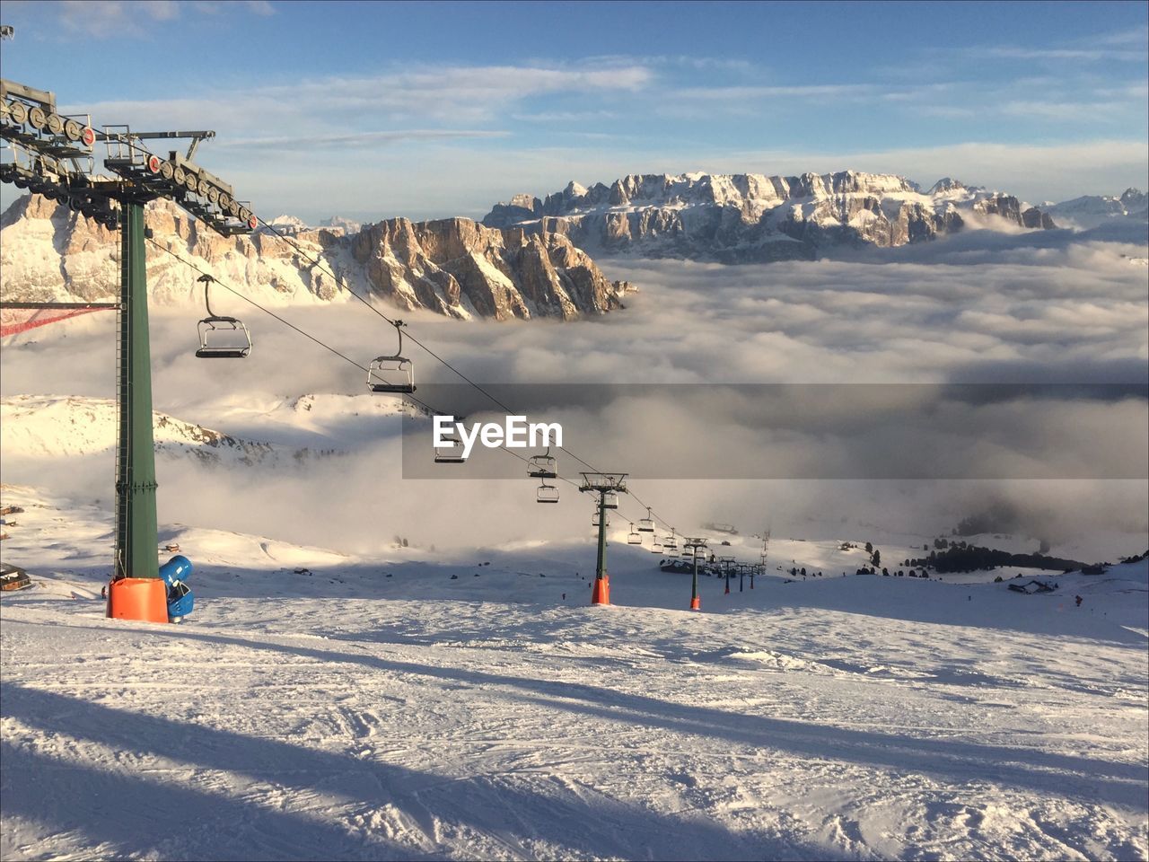 Scenic view of snow covered mountains and calley filled with low clouds against sky