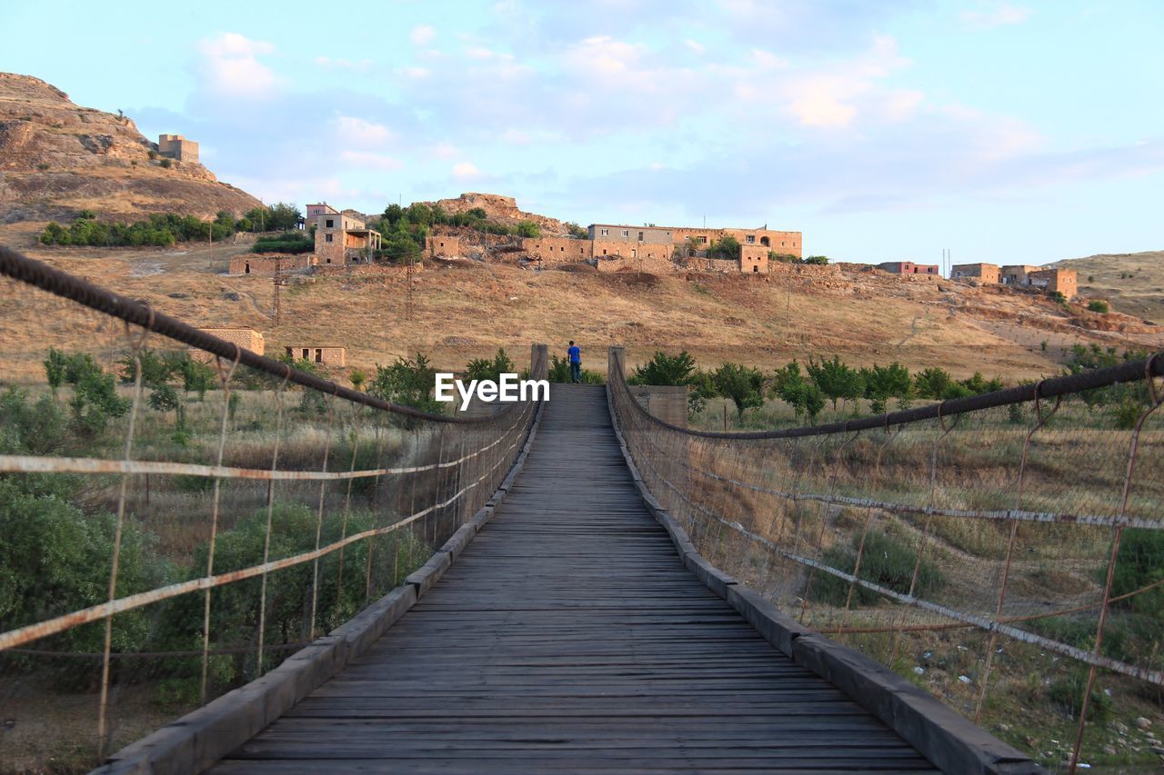 Footbridge against sky