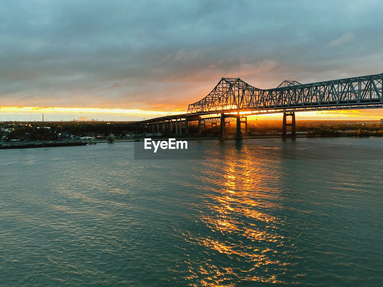 Bridge over river during sunset