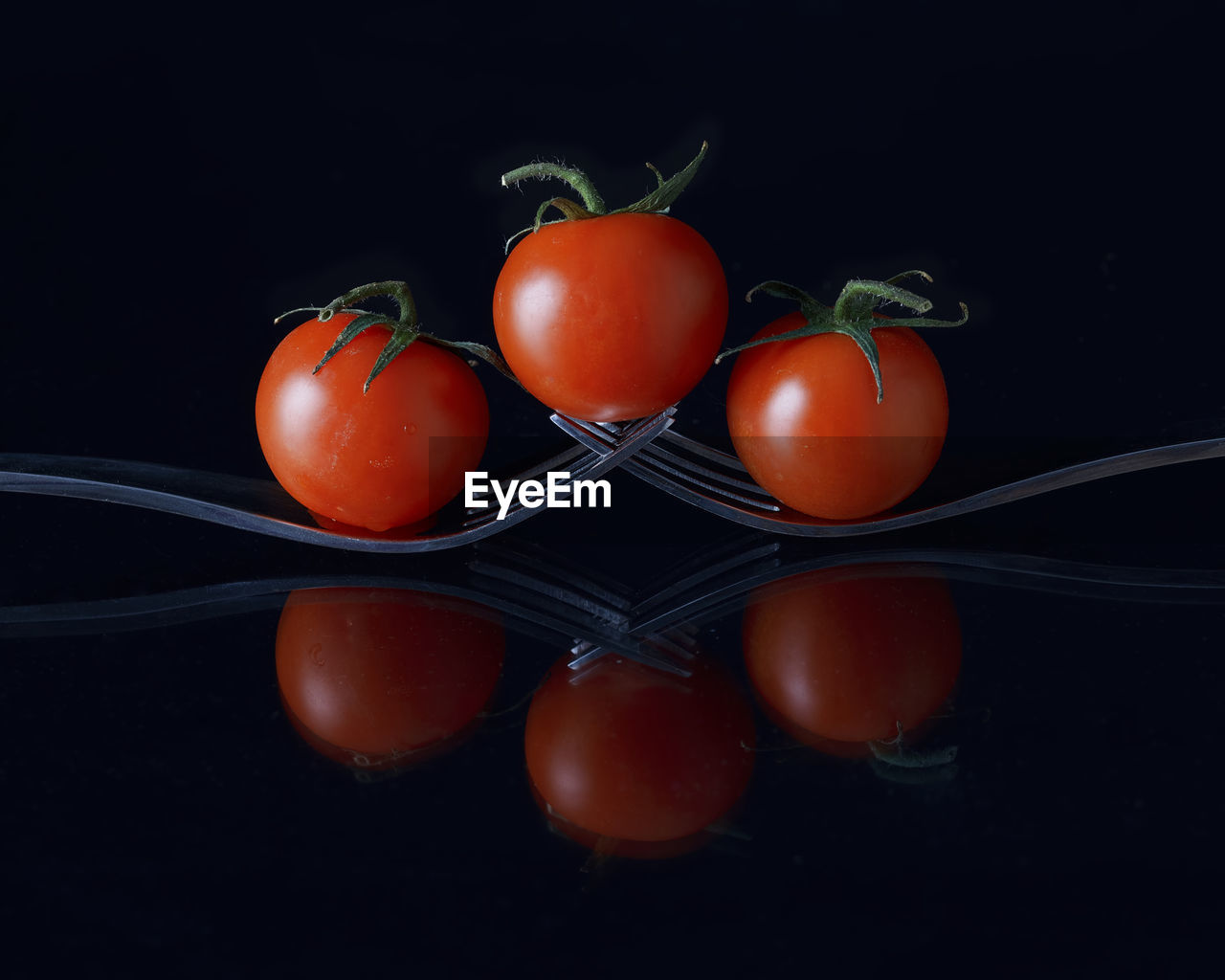 Close-up of cherry tomatoes against black background