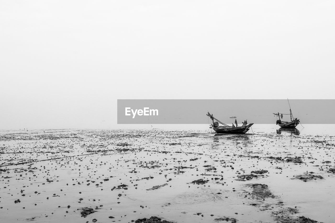 FISHING BOATS ON SEA AGAINST CLEAR SKY