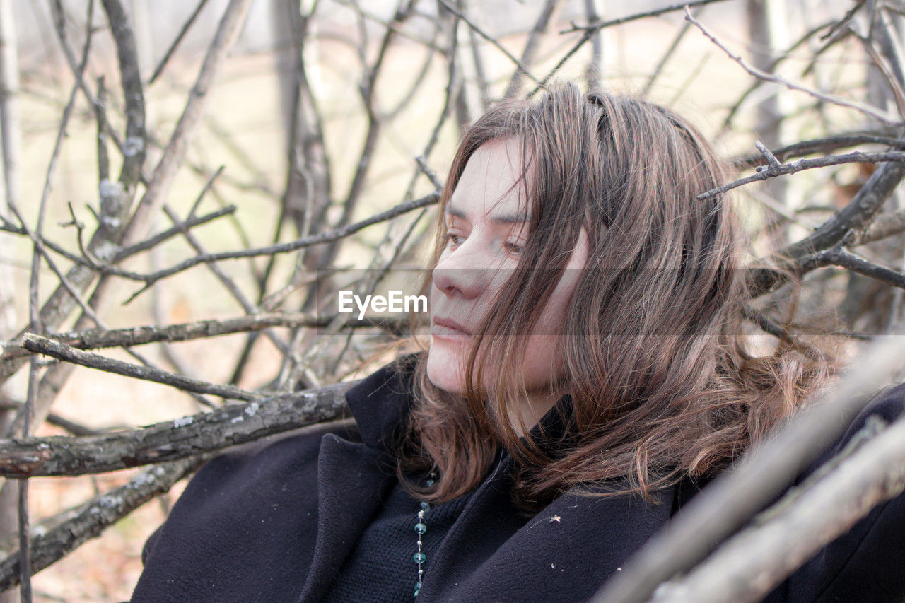 spring, winter, one person, tree, women, adult, nature, hairstyle, long hair, portrait, bare tree, young adult, plant, portrait photography, forest, land, headshot, cold temperature, clothing, female, looking, leisure activity, outdoors, person, branch, lifestyles, human face, emotion, tranquility, fashion, day, human hair, warm clothing, sadness, blond hair, autumn, photo shoot, contemplation, casual clothing, environment, selective focus, brown hair, jacket, landscape