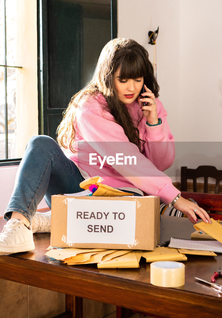 portrait of young woman using digital tablet while sitting at home