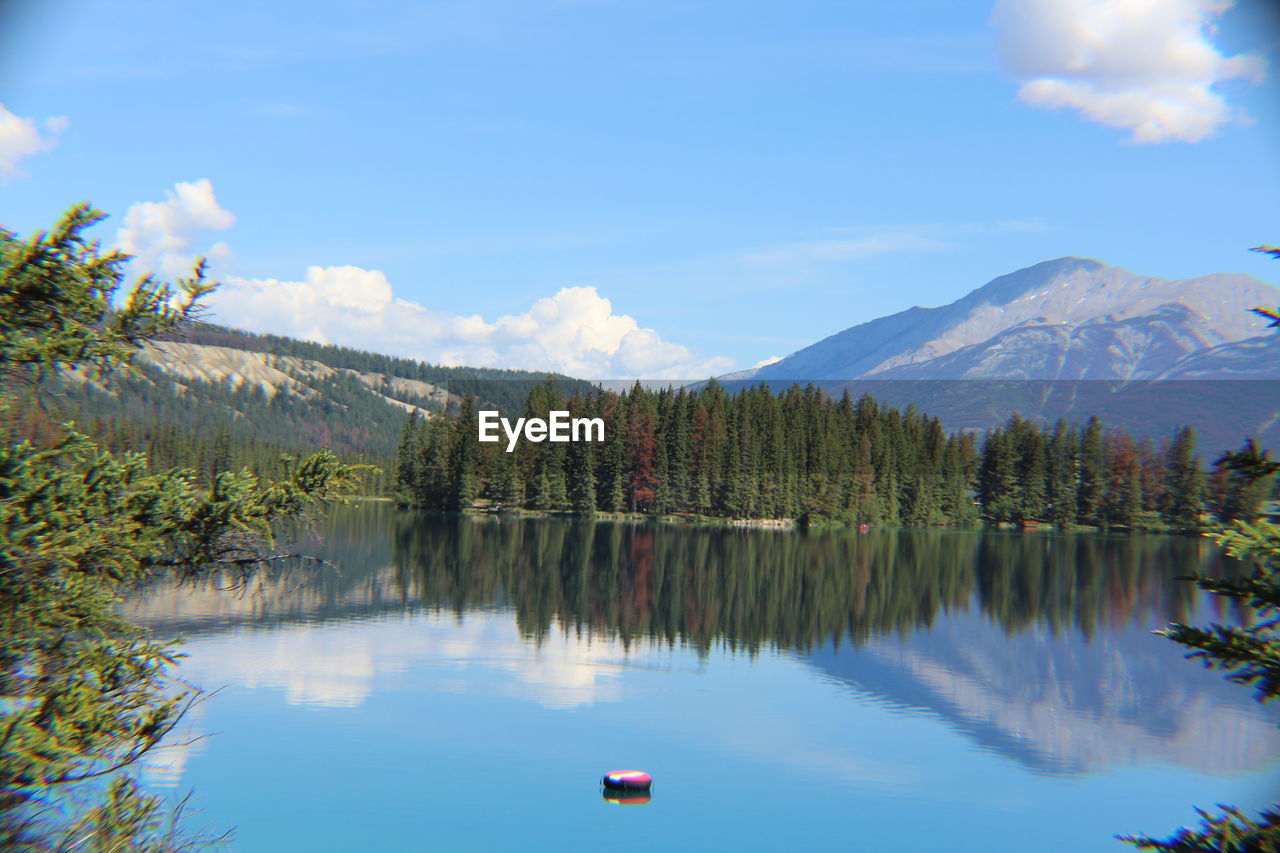 Scenic view of lake and mountains against sky