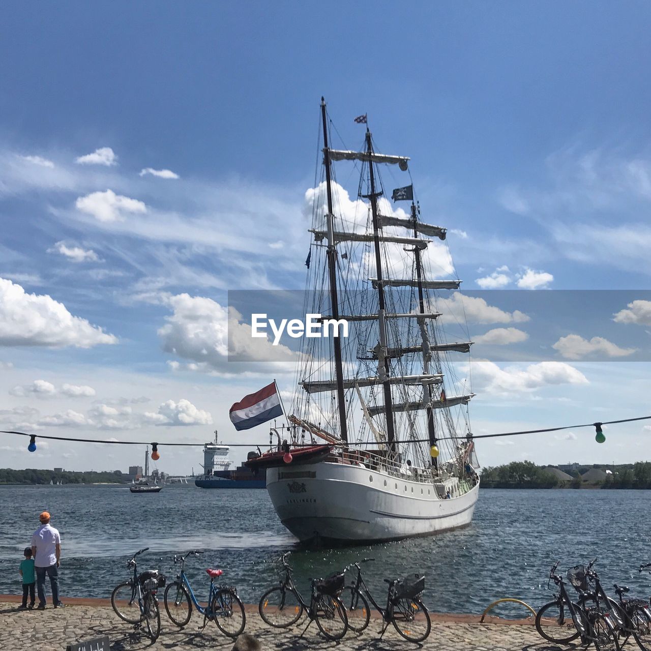 SHIP AT HARBOR AGAINST SKY