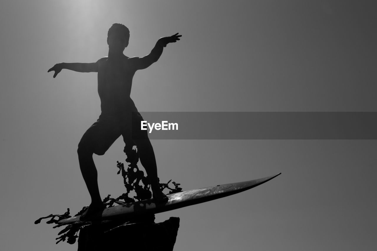 LOW ANGLE VIEW OF SILHOUETTE MEN AGAINST SKY