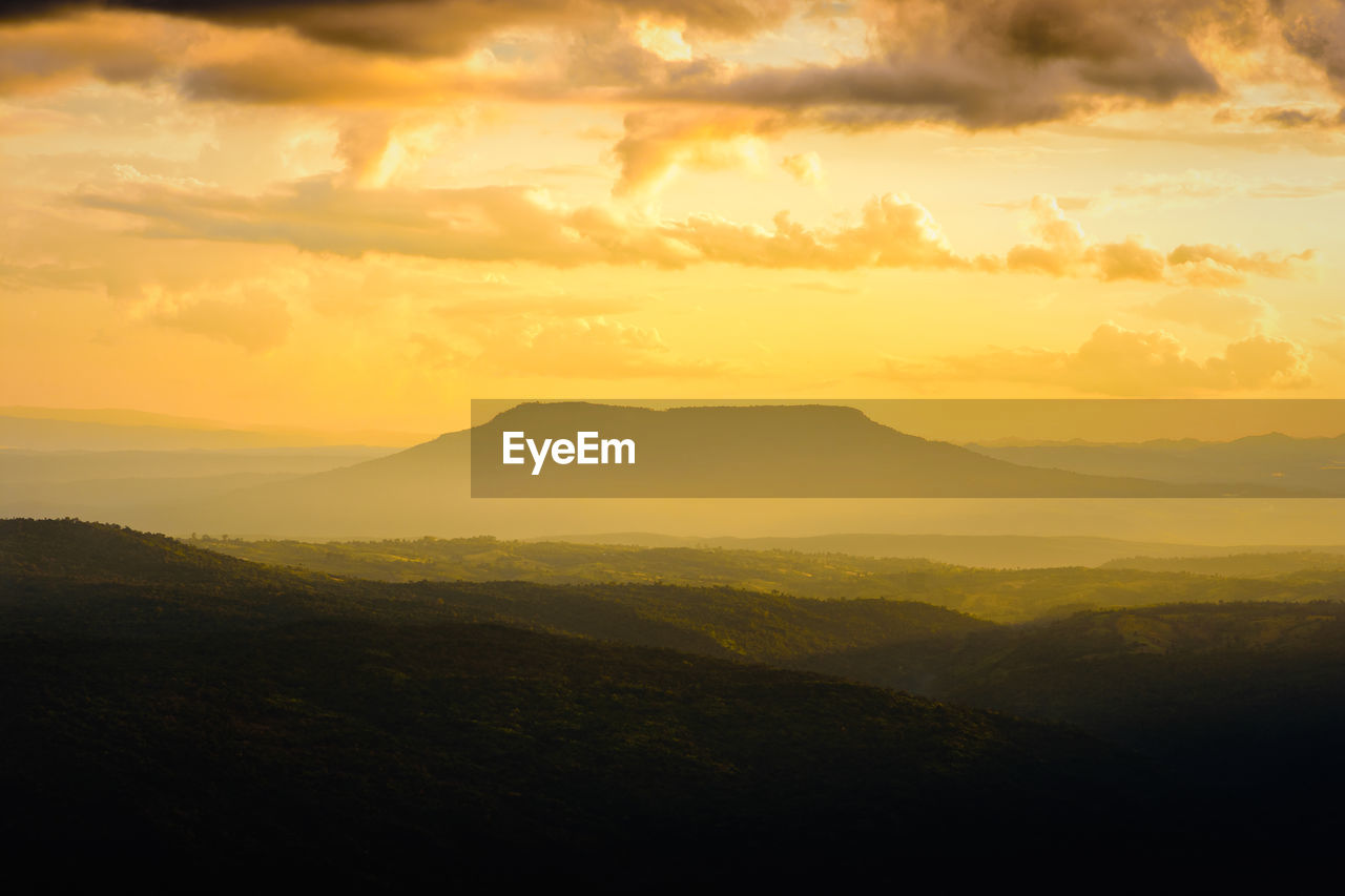 SCENIC VIEW OF MOUNTAINS AGAINST DRAMATIC SKY