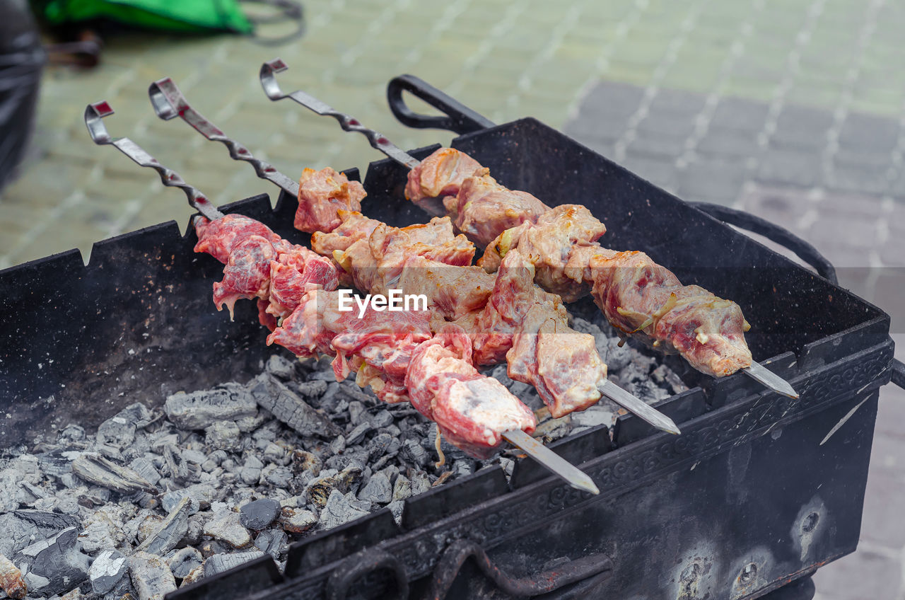 Cooking kebabs on fire up close. appetizing kebabs. meat on skewer. barbecue with charcoal.