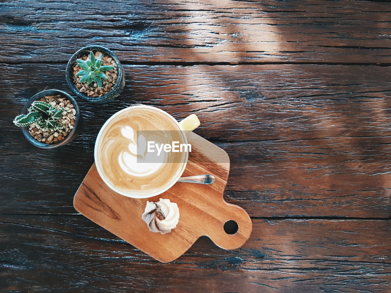 HIGH ANGLE VIEW OF COFFEE CUP WITH TEXT ON TABLE