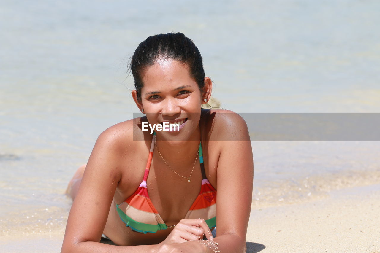 Portrait of smiling woman on beach