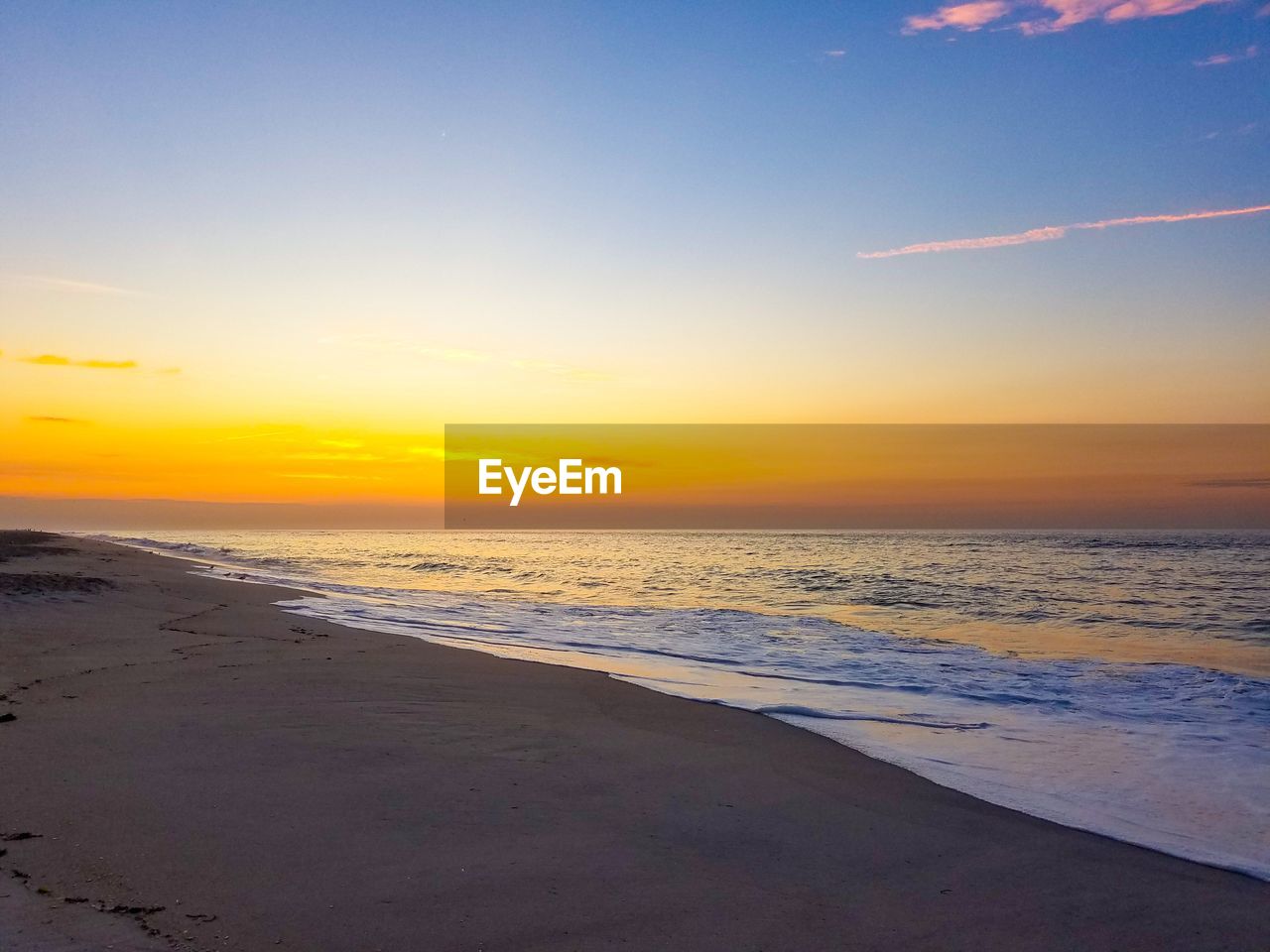 SCENIC VIEW OF BEACH DURING SUNSET