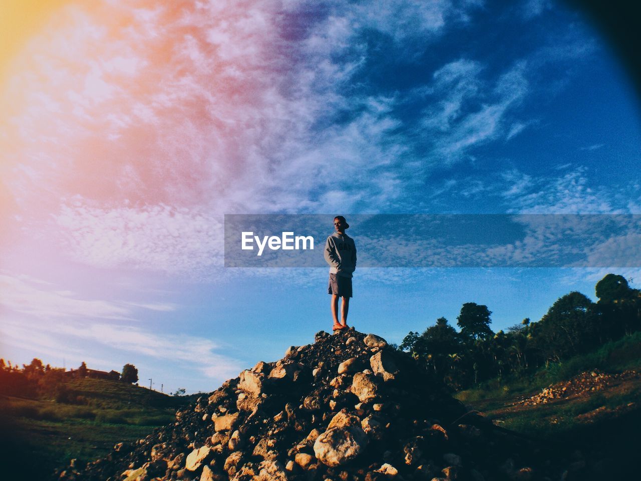 FULL LENGTH OF WOMAN STANDING ON ROCKS