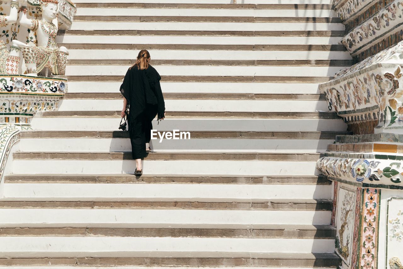 MAN STANDING ON STEPS