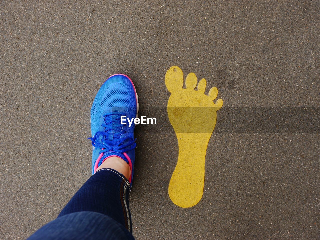 Low section view of person standing on footprint
