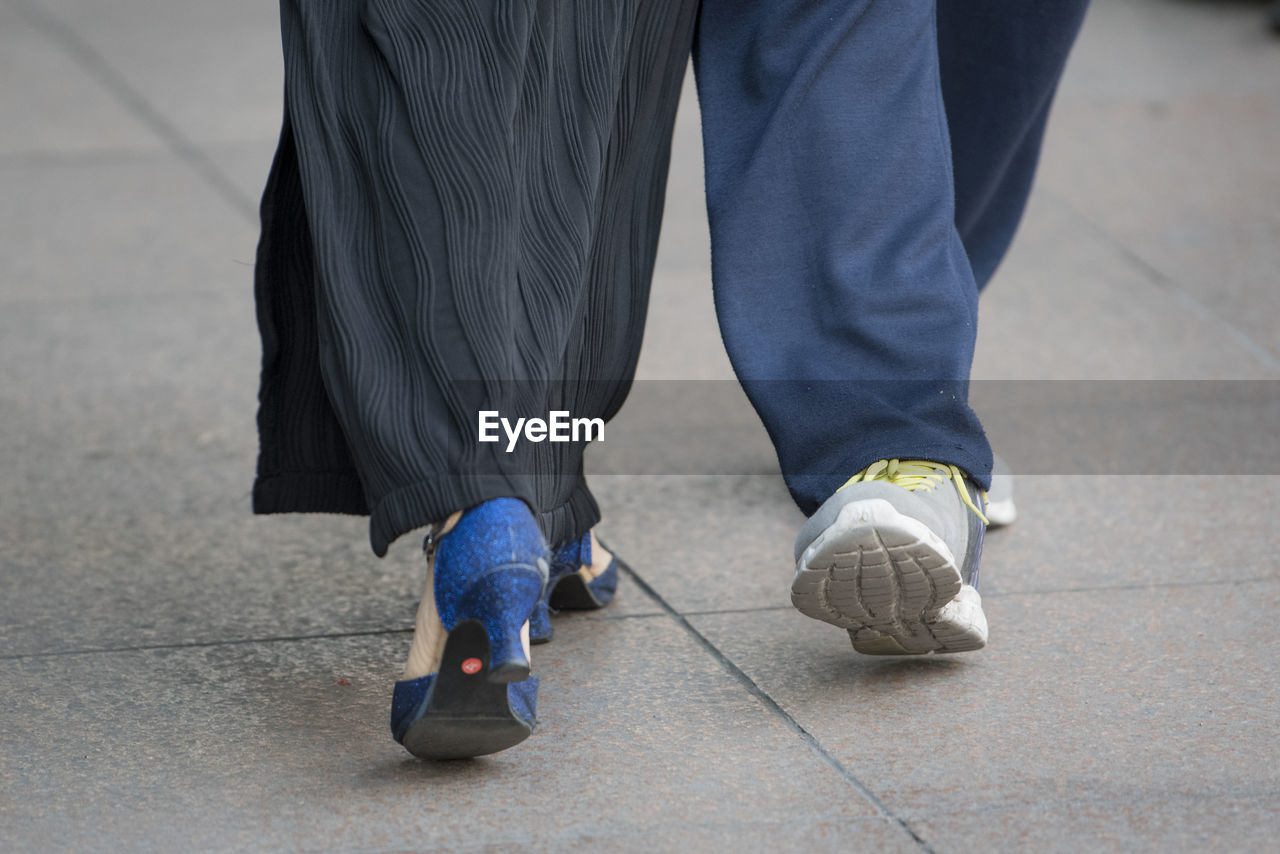 Low section of people walking on road