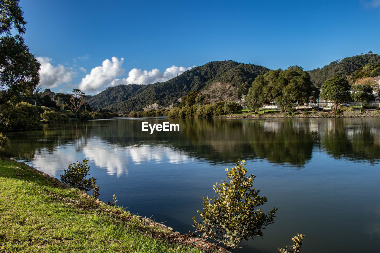 Scenic view of lake and mountains against sky