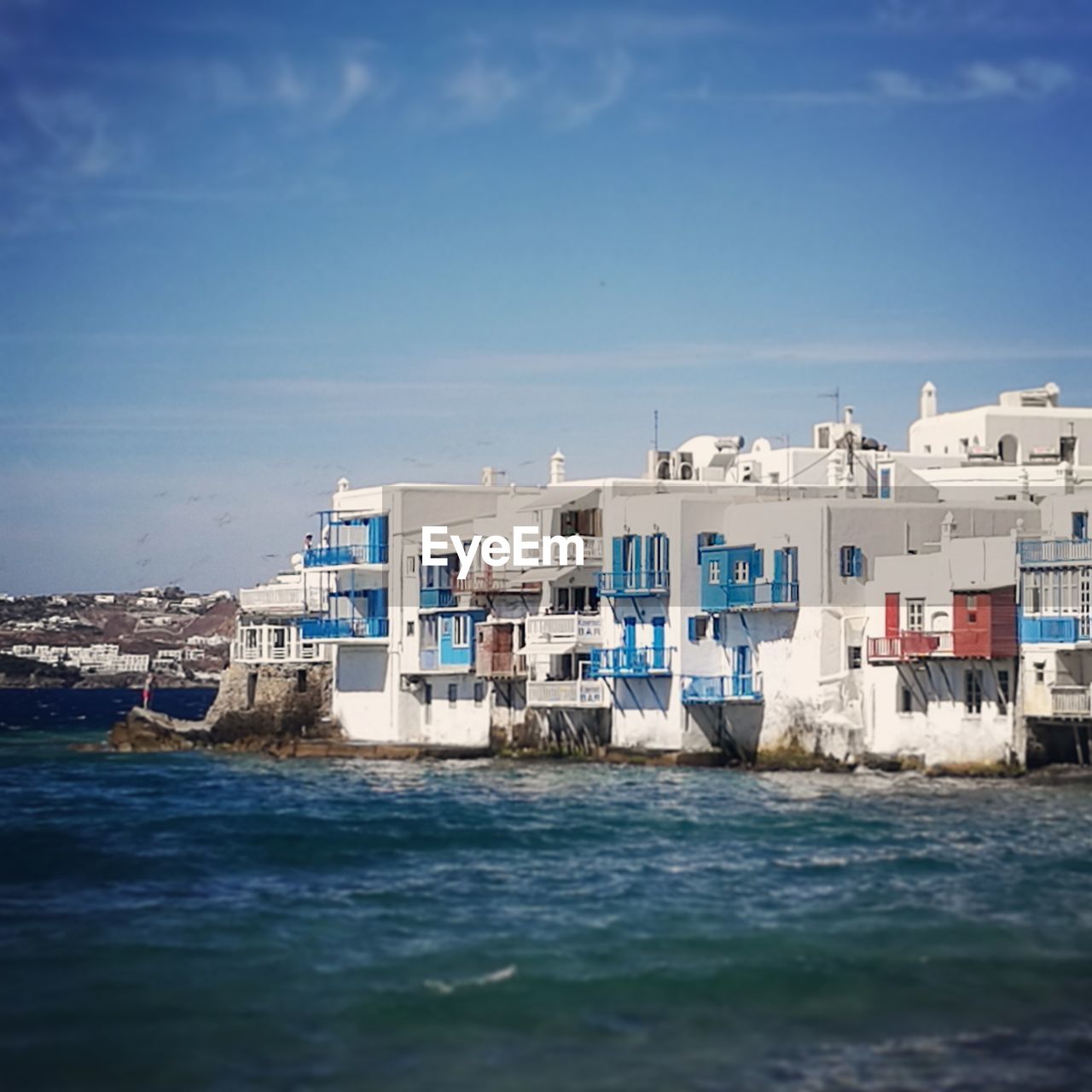 VIEW OF CALM SEA IN FRONT OF BUILT STRUCTURES