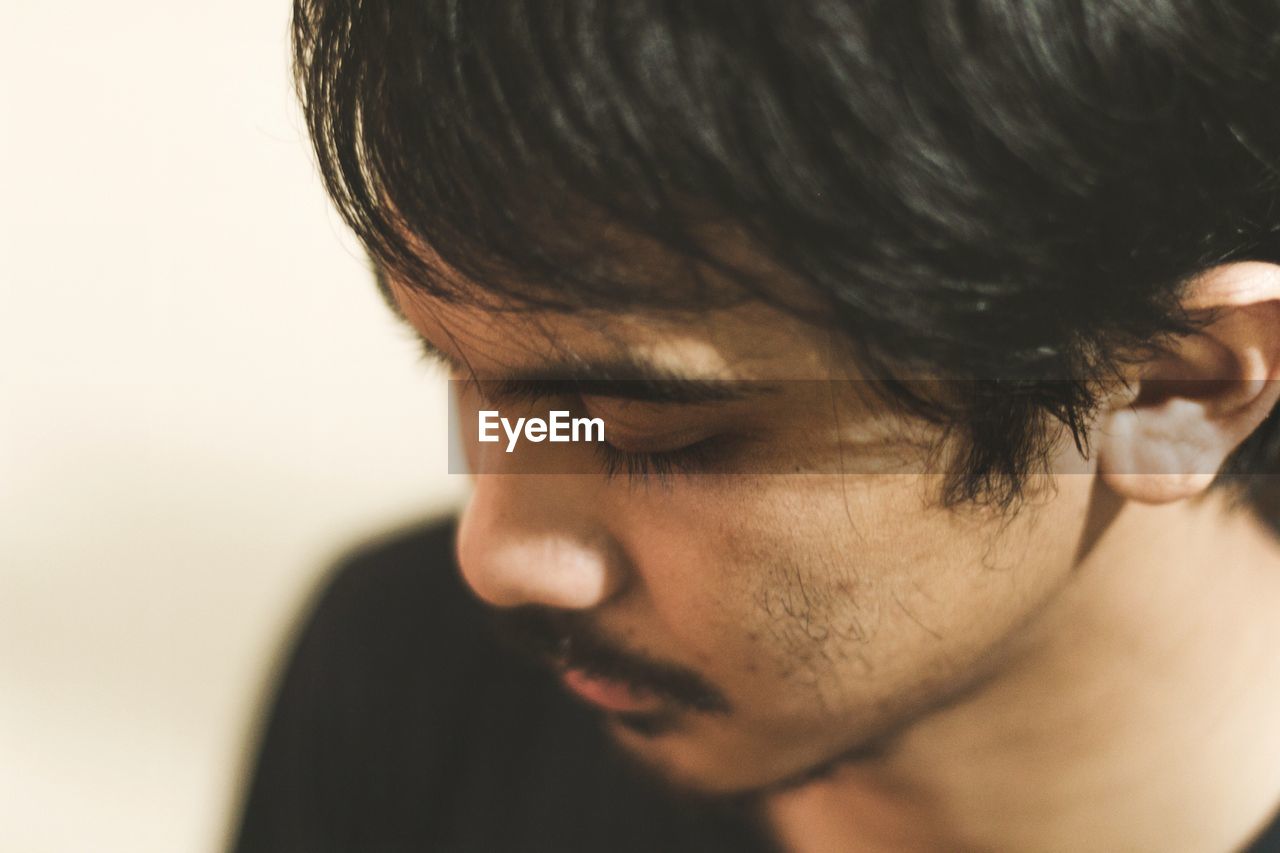 High angle close-up of young man at home