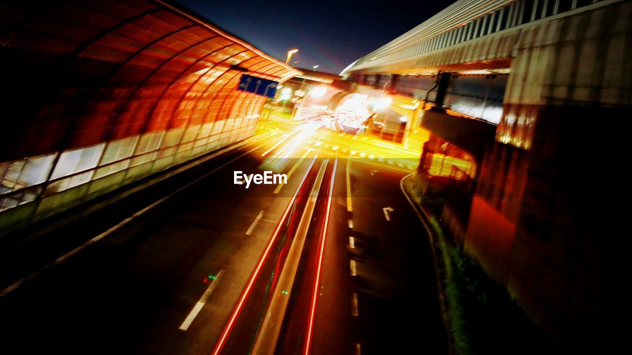 LIGHT TRAILS ON ROAD IN CITY