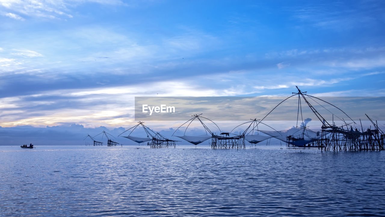 SAILBOATS IN SEA AGAINST BLUE SKY