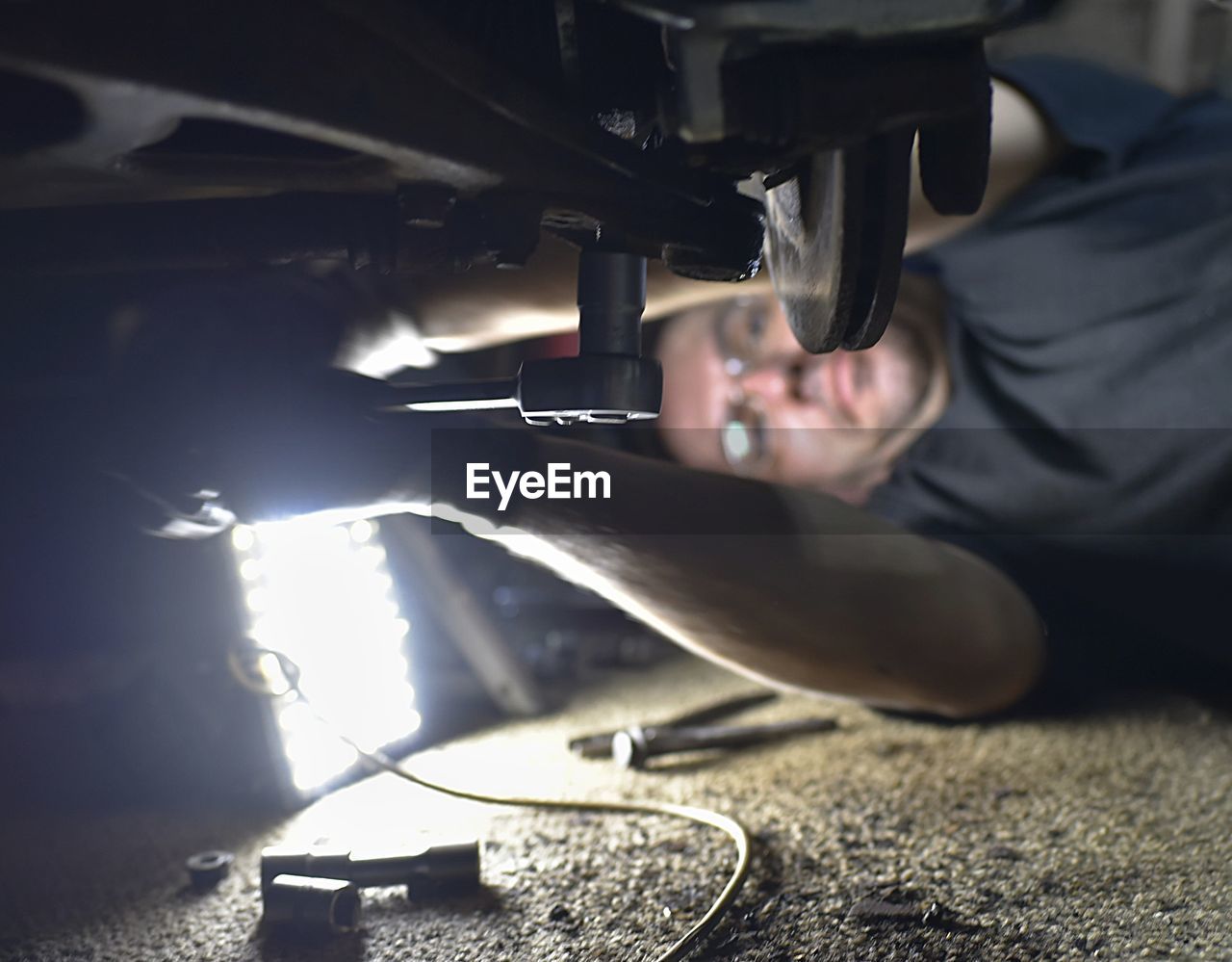 Close-up of man repairing car in workshop