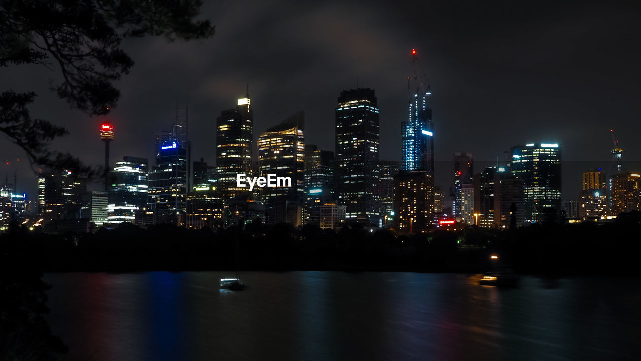 Beautiful sydney harbor with office buildings light and illumination at night.