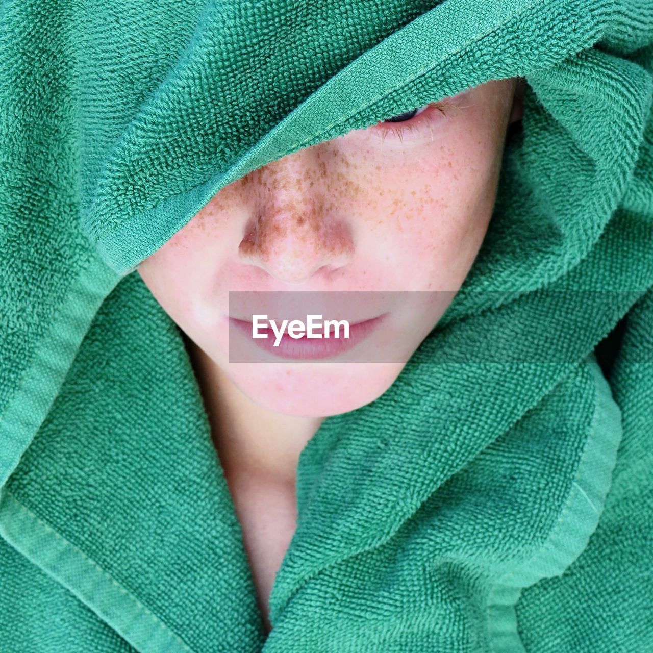 Close-up of boy wrapped in towel
