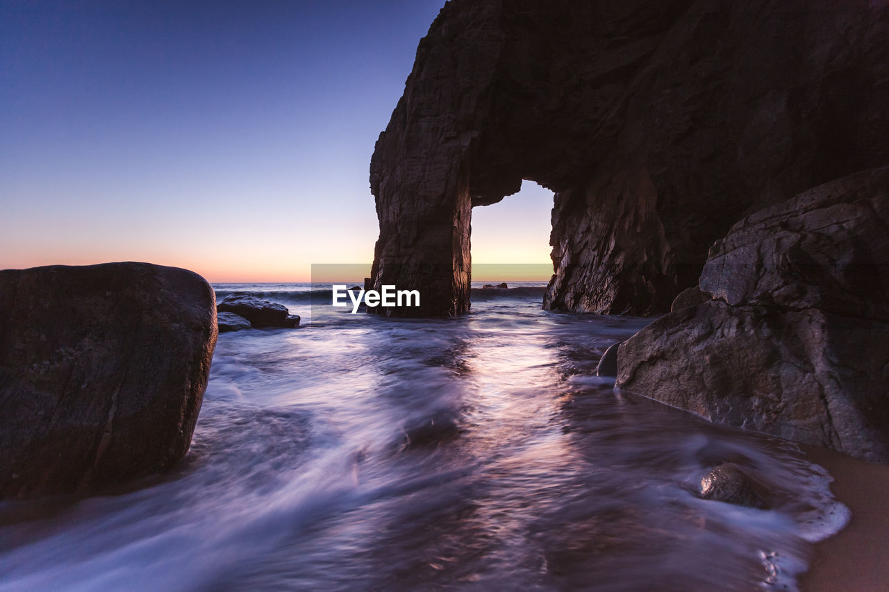 Scenic view of sea against clear sky during sunset