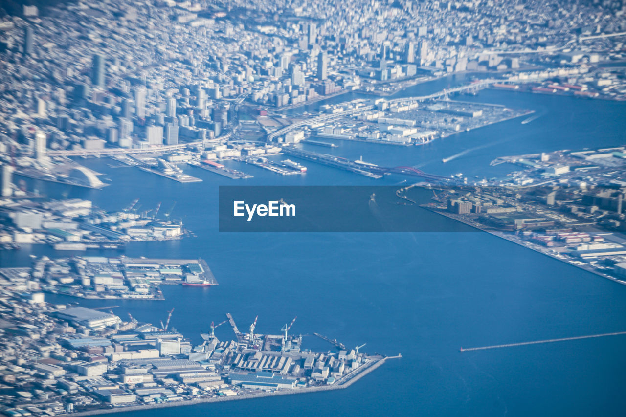 HIGH ANGLE VIEW OF CITY BY SEA AND BUILDINGS