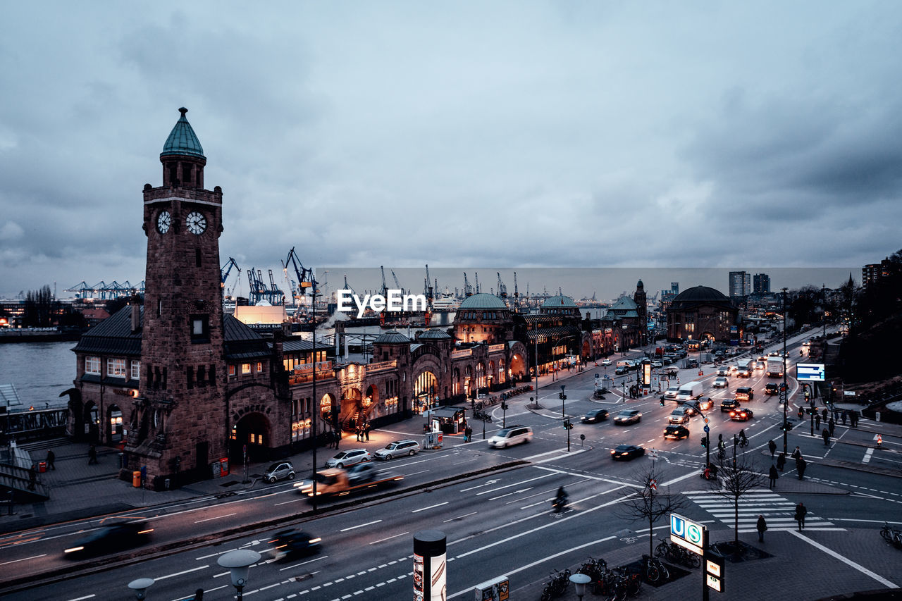 High angle view of city street against cloudy sky