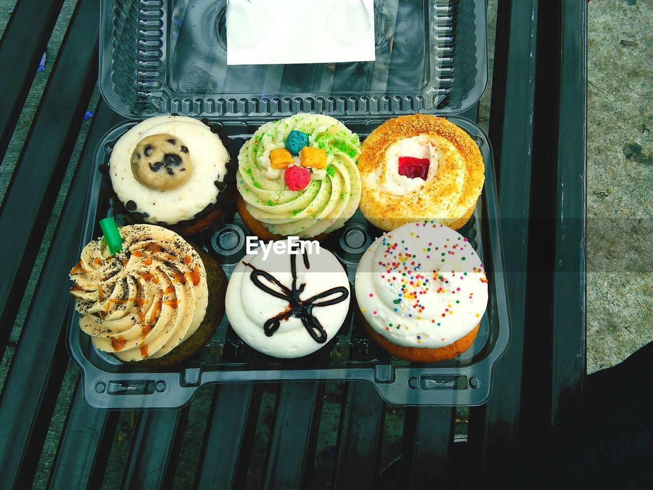 High angle view of cupcakes in plastic container on bench